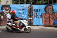A mural shows two Papuans with the words: &ldquo;If we are monkeys, don&rsquo;t force monkeys to raise the white and red [Indonesian] flag. Stop racism.&rdquo; The mural was displayed on a road connecting Depok and Bogor, West Java. The mural refers to an incident last year in Surabaya, East Java, in which a Papuan student was vilified and called a &ldquo;monkey&rdquo;. The incident led to a string of antiracism protests. 