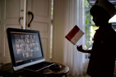 Young patriot: Rashan (5) participates in a online commemoration of the Indonesia Independence Day which is held by Al Izhar Kindergarten in Jakarta, on Monday, August 17, 2020. The Commemoration is held online to orevent further spread if the Covid 19 virus. JP/ Seto Wardhana