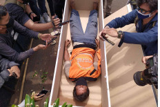 A man is made to lie in a coffin for failing to wear a face mask in Kalisari, East Jakarta, on Thursday, September 3. 2020. A joint team of Jakarta Public Order Agency (Satpol PP), police and military personnel handed down the controversial punishment to health protocol offenders in the area. The joint team eventually decided to stop the punishments following widespread criticism.  JP/P.J. Leo