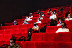 Jakarta administration officials and volunteers participate in a movie screening simulation at a Cinema XXI theater in Cililitan, East Jakarta, on Saturday. August 29. 2020. The Jakarta administration plans to allow cinemas in the city to reopen with tight health protocols. JP/Seto Wardhana