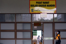 A cleaner works outside the Patriot Candrabhaga Stadium in Bekasi, West Java, on October. 2. 2020. The stadium now houses Bekasi&rsquo;s asymptomatic COVID-19 patients. JP/Dhoni Setiawan