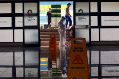 A medical worker checks on the condition of a COVID-19 patient undergoing isolation at the Patriot Candrabhaga Stadium in Bekasi, West Java, on Oct. 2. Medical personnel routinely monitor patients&rsquo; conditions. JP/Dhoni Setiawan