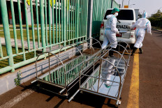 Medical personnel roll out biers from an ambulance in the Patriot Candrabhaga Stadium in Bekasi, West Java, on October. 2. 2020. The ambulance will be used to pick up asymptomatic COVID-19 patients who will undergo independent isolation at the stadium. JP/Dhoni Setiawan