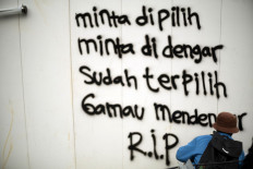 Graffitti protest: Words spray-painted on a wall in Jakarta reflect the sense of public betrayal that has fueled three days of nationwide demonstrations against the omnibus bill on job creation, which the House of Representatives passed on Monday. The graffiti reads: &ldquo;Want to be elected/Want to be heard/After [they are] elected/They don&rsquo;t want to hear. R.I.P.&rdquo; JP/Seto Wardhana 