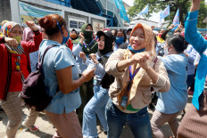 Workers of PT Panarub Industry sports footwear factory dance during a protest held in front of the factory in Tangerang, Banten, on Oct. 7. The workers voiced their concerns over the newly passed Job Creation Law during the protest. JP/Dhoni Setiawan