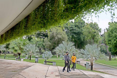 Residents walk around Banteng Park in Jakarta on Oct. 18. The Jakarta administration has reopened green public spaces in the city during the transitional large-scale social restrictions. JP/Wendra Ajistyatama