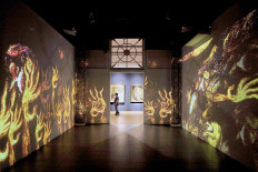 Visitors look at a video display on Nov. 1, 2020 during the "Immersive Affandi: Human, Space, Nature" exhibition, which runs from Oct. 26 to Nov. 25 at the National Gallery of Indonesia in Jakarta. JP/Seto Wardhana