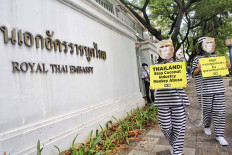 PETA activists dressed as monkey inmates protest outside the Royal Thai Embassy in Jakarta on Dec. 8. The protesters called on Thailand to end the use of monkey labor in the country&rsquo;s coconut industry. Monkeys, typically fitted with metal collars and chained for life, are often used to harvest coconuts at plantations. JP/Seto Wardhana