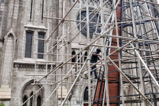 A worker assembles a giant Christmas tree in front of the St. Mary of Assumption Cathedral in Central Jakarta on Dec. 15. The giant tree was erected as part of the 2020 Christmas celebrations. JP/Seto Wardhana