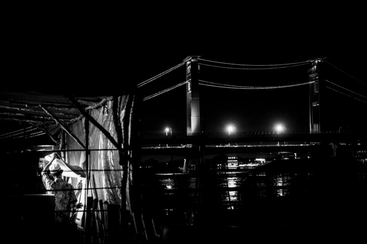 Members of polling station working committees (KPPS) count ballot papers at Kawasan 10 Ulu on April 17, 2019, in Palembang, South Sumatra. The vote counting process ran into the night.