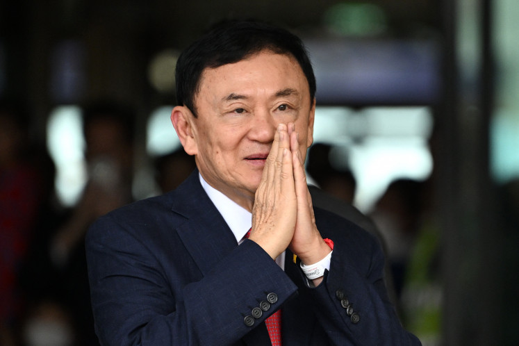 Former Thai prime minister Thaksin Shinawatra greets his supporters on August 22, 2023, after landing at Bangkok's Don Mueang International Airport. Thai prosecutors formally indicted Thaksin on Tuesday under the kingdom's strict l&egrave;se-majest&eacute; law over comments he made nearly a decade ago.