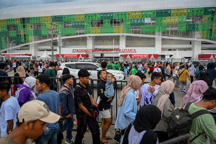 United in sport: People walk in the North Sumatra Main Stadium area on Sept. 20, 2024, to watch the closing ceremony of PON XXI Aceh-North Sumatra 2024 in Deli Serdang, North Sumatra. The event involved nearly 13,000 athletes from 38 provinces competing in 65 sports. 