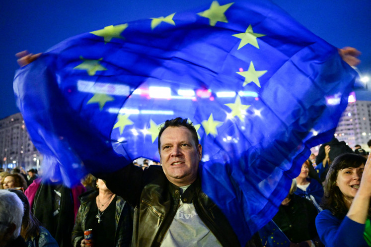 A man holds an EU flag during a pro-Europe rally in Bucharest, Romania, on March 15, 2025.