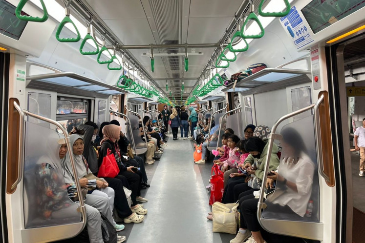 Passengers take the Commuter Line Bogor commuter train on board the new Chinese-made electric railcar train on Sunday, June 1. Commuter Line train operator PT Kereta Commuter Indonesia started the operation of two new trains for Commuter Line Bogor and one train for Commuter Line Cikarang. 