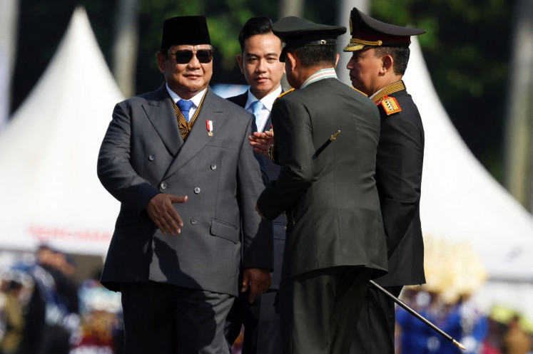 Navigating challenges: President Prabowo Subianto (left) and Vice President Gibran Rakabuming Raka (second left) attend a ceremony on July 1 to mark the 79th anniversary of the National Police at the National Monument (Monas) in Jakarta. 