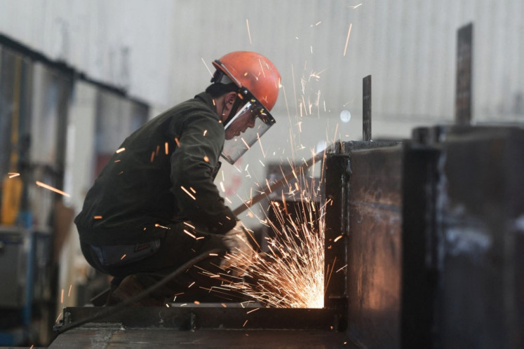 A welder works on July 15, 2025, at a steel structure fabrication factory in Hangzhou, Zhejiang province, East China.